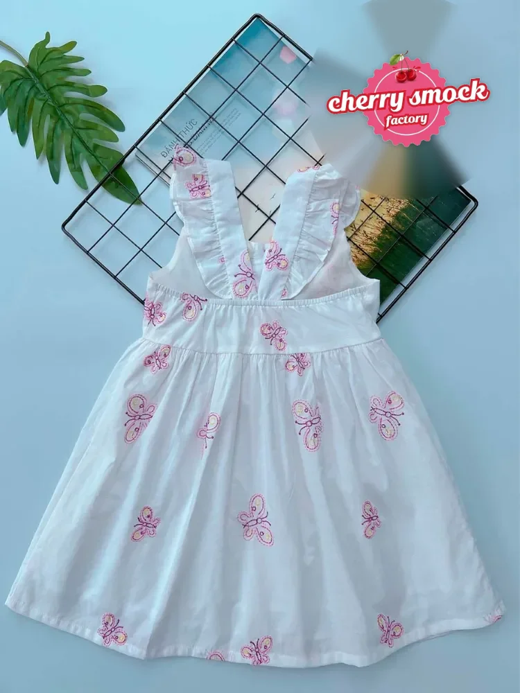 Low MOQ smocked dresses: Butterfly two-string girls dress with hand smocked bodice, available from 30 pieces per design