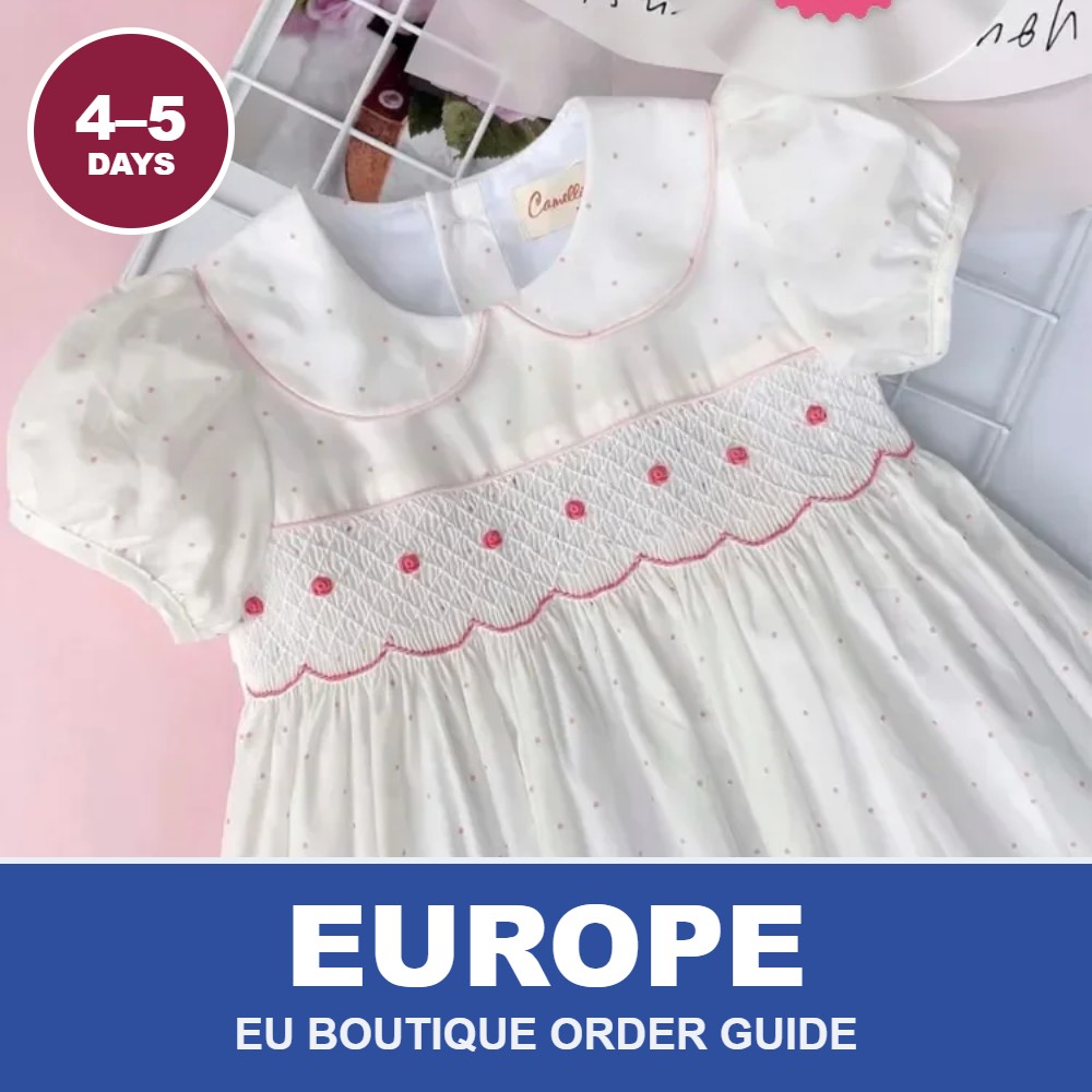 White hand-smocked dress with red details from Cherrysmock for European boutique wholesale